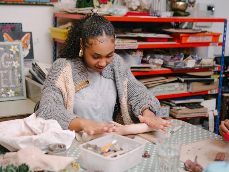 Woman rolling out clay
