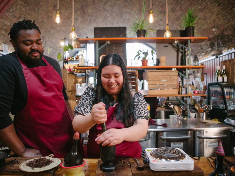 Couple grinding coffee at a barista course