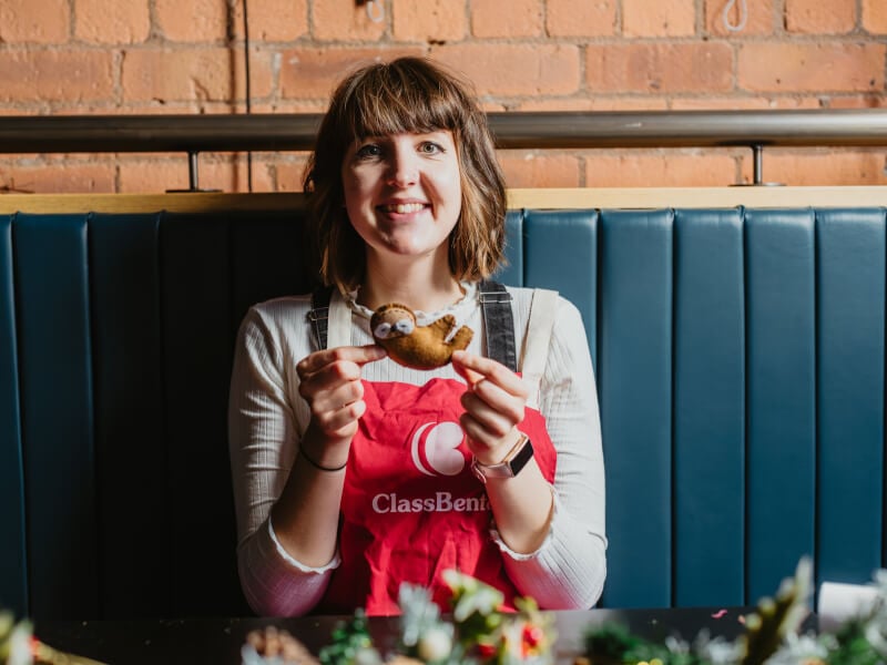 Woman holding up DIY ornament