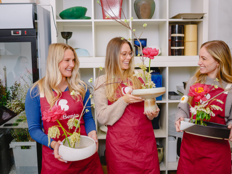 Women smiling and holding their DIY Ikebana arrangements