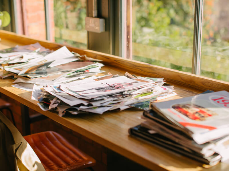 A collection of papers and magazines on the table
