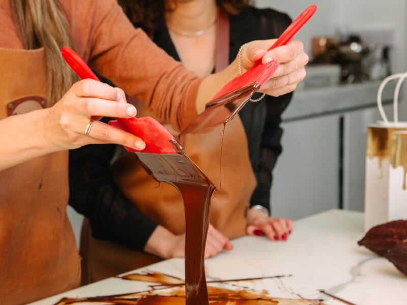 Woman's hands tempering chocolate 