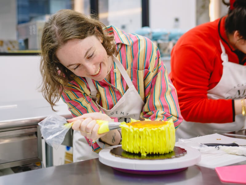 Woman decorating a cake