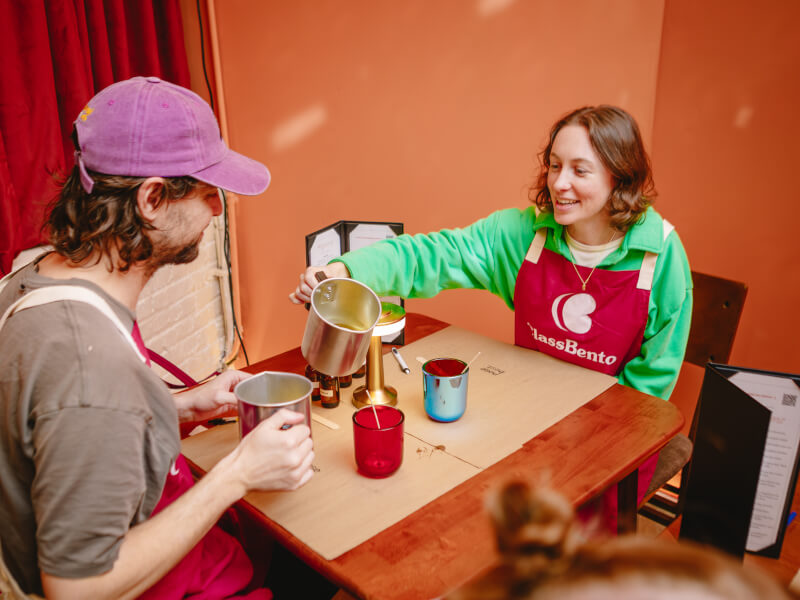 Woman pouring wax at a candle making class