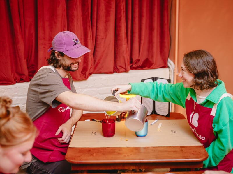 Couple pouring candle waxes for each other