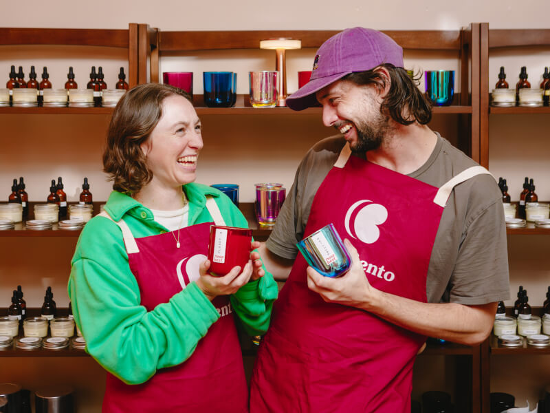 People smiling at each other, holding their candles