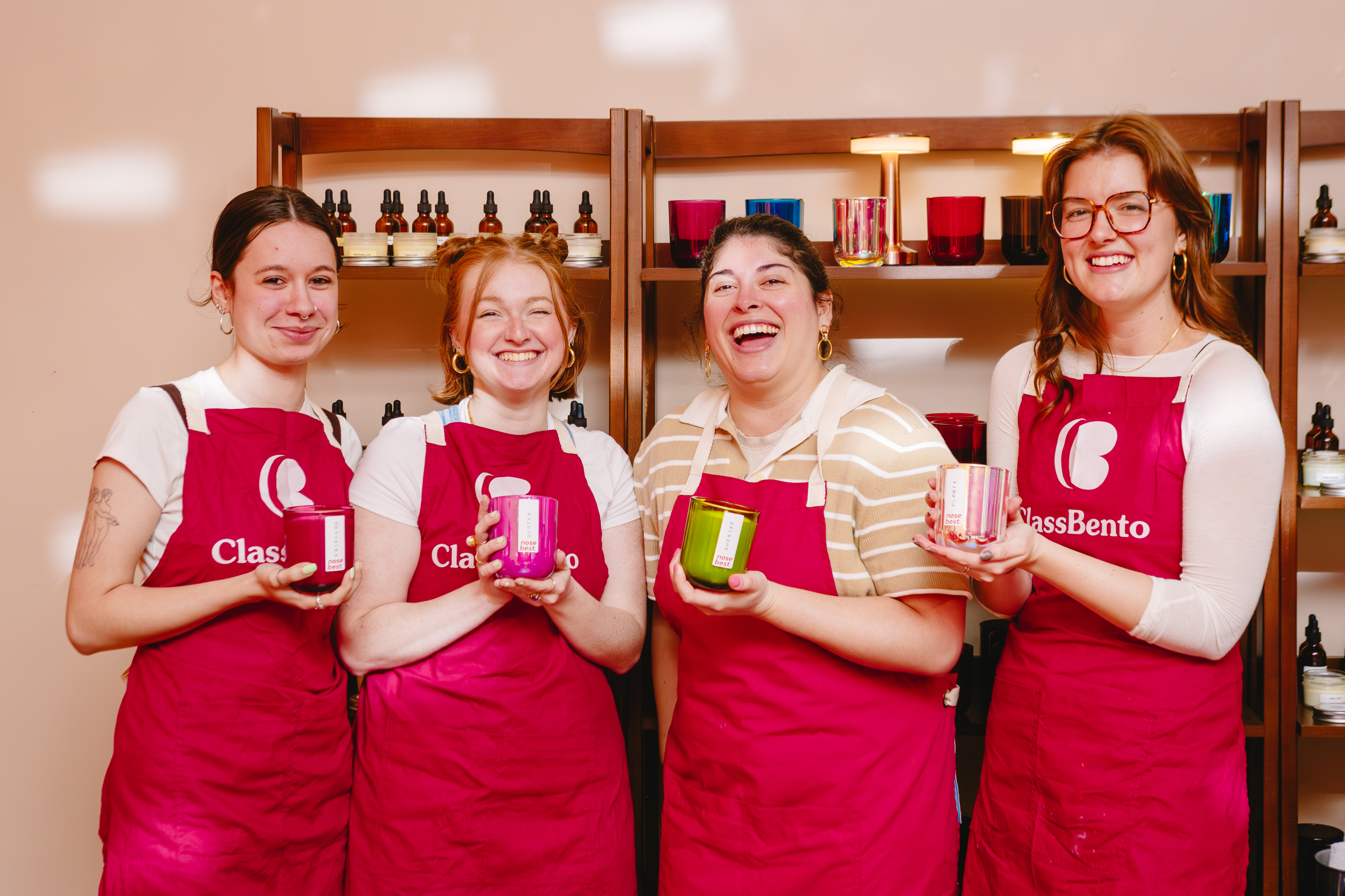 A group of women showing off their finished candles