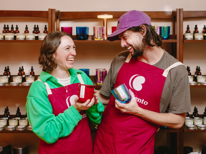 Couple smiling and holding their candles