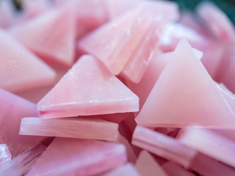 Close-up of small triangular pink glass tiles