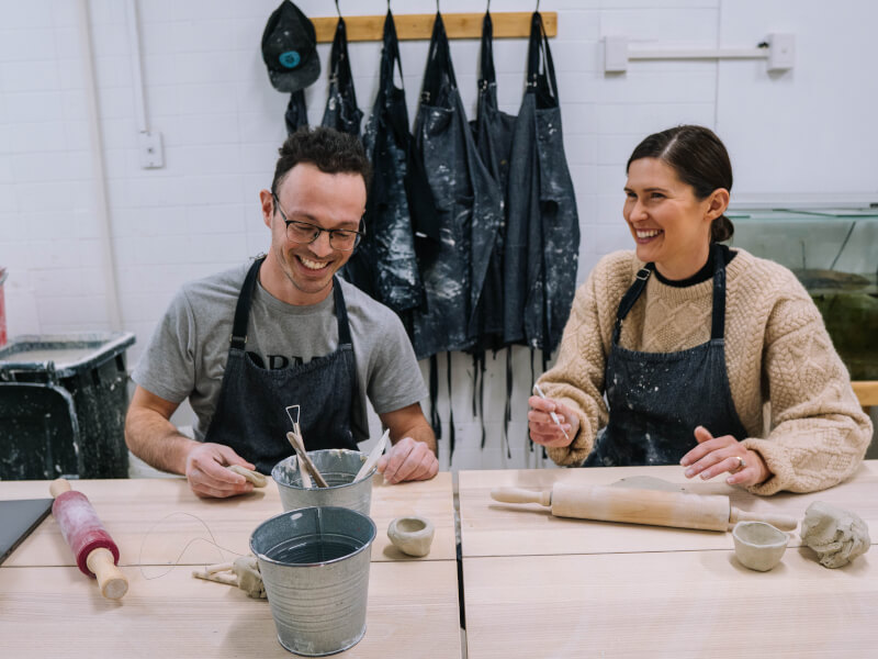 couple laughing at hand building class
