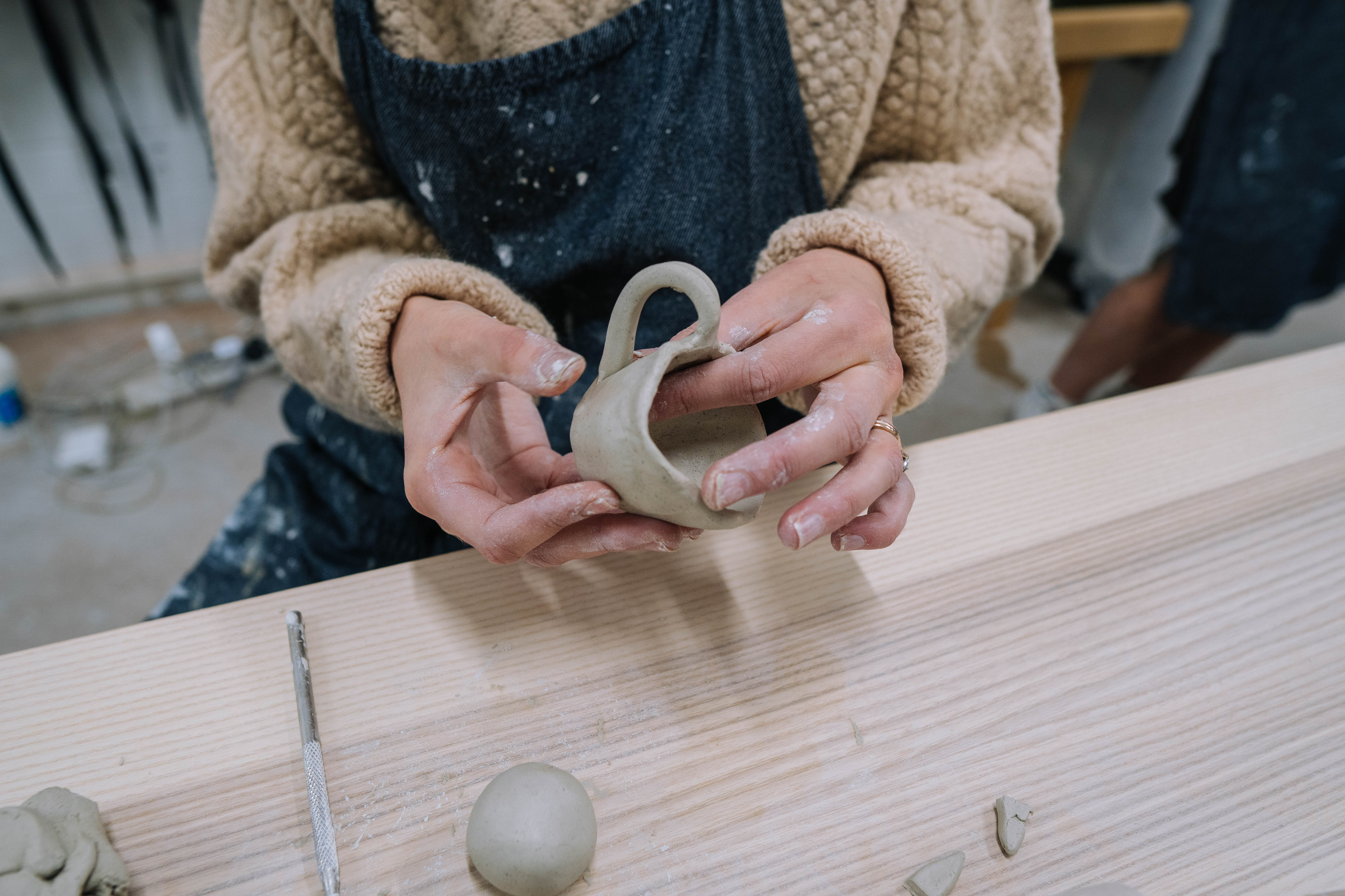 Close-up of woman hand building a mug