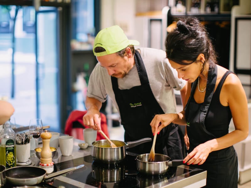 Couple cooking together in an industrial kitchen