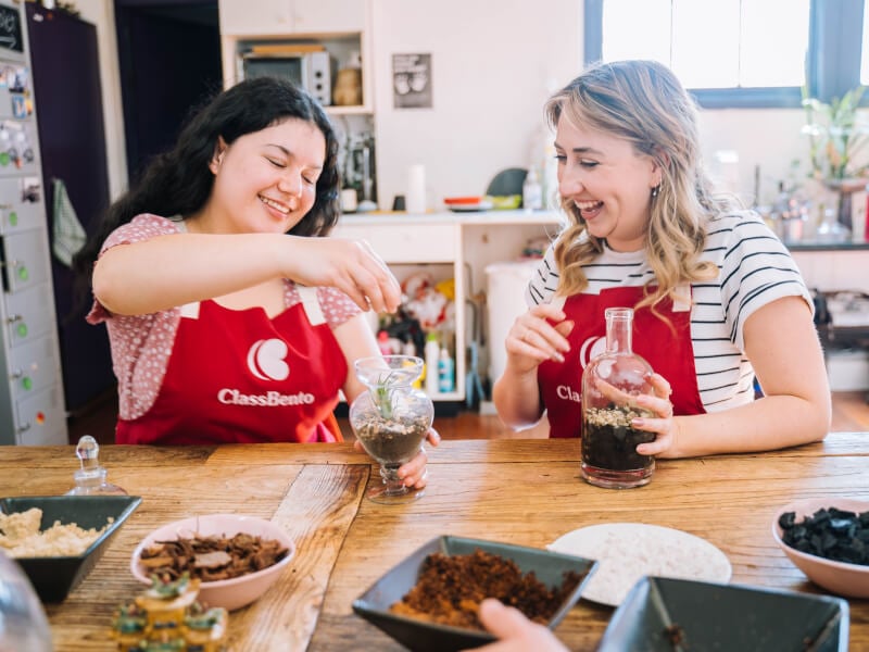 Two friends enjoy making terrariums as a Christmas present