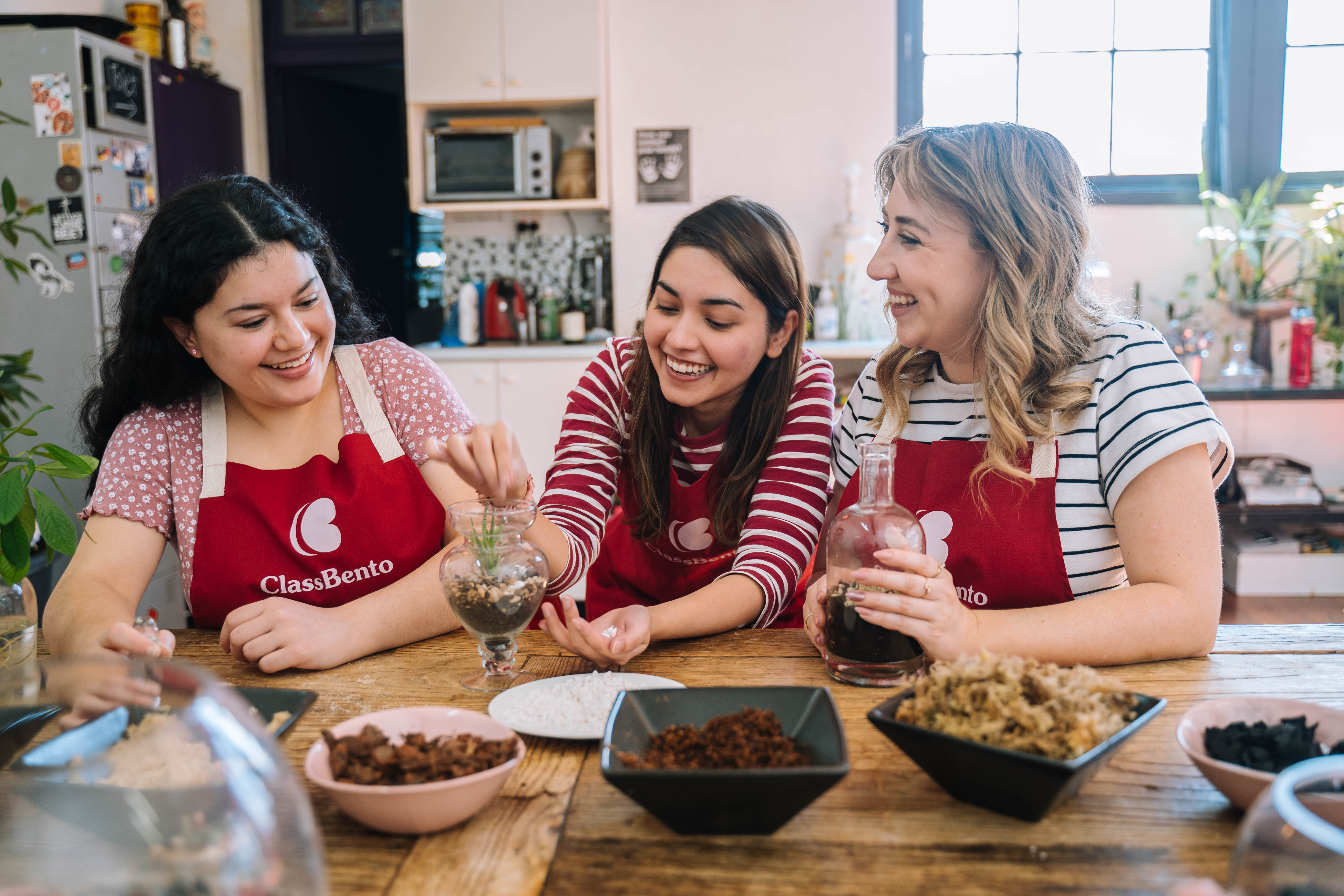 Three women enjoying a terrarium class