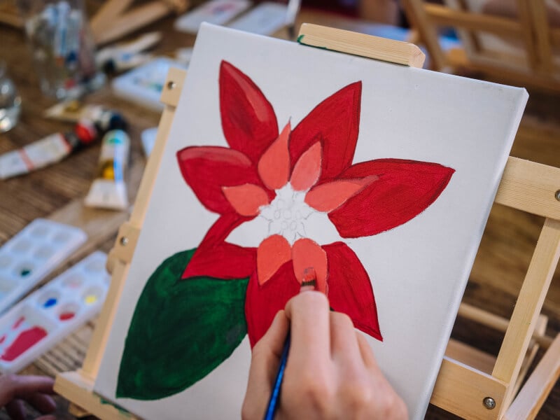 Close-up of person painting a Christmas artwork