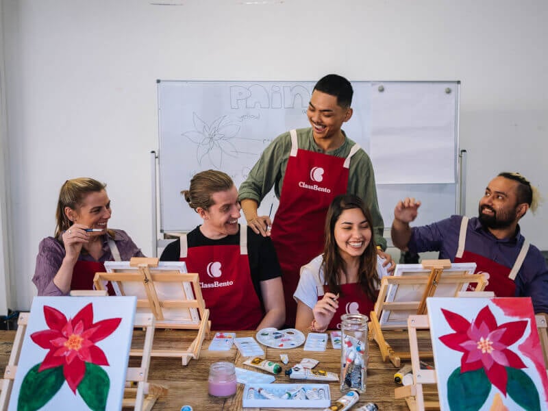 People enjoying a painting class