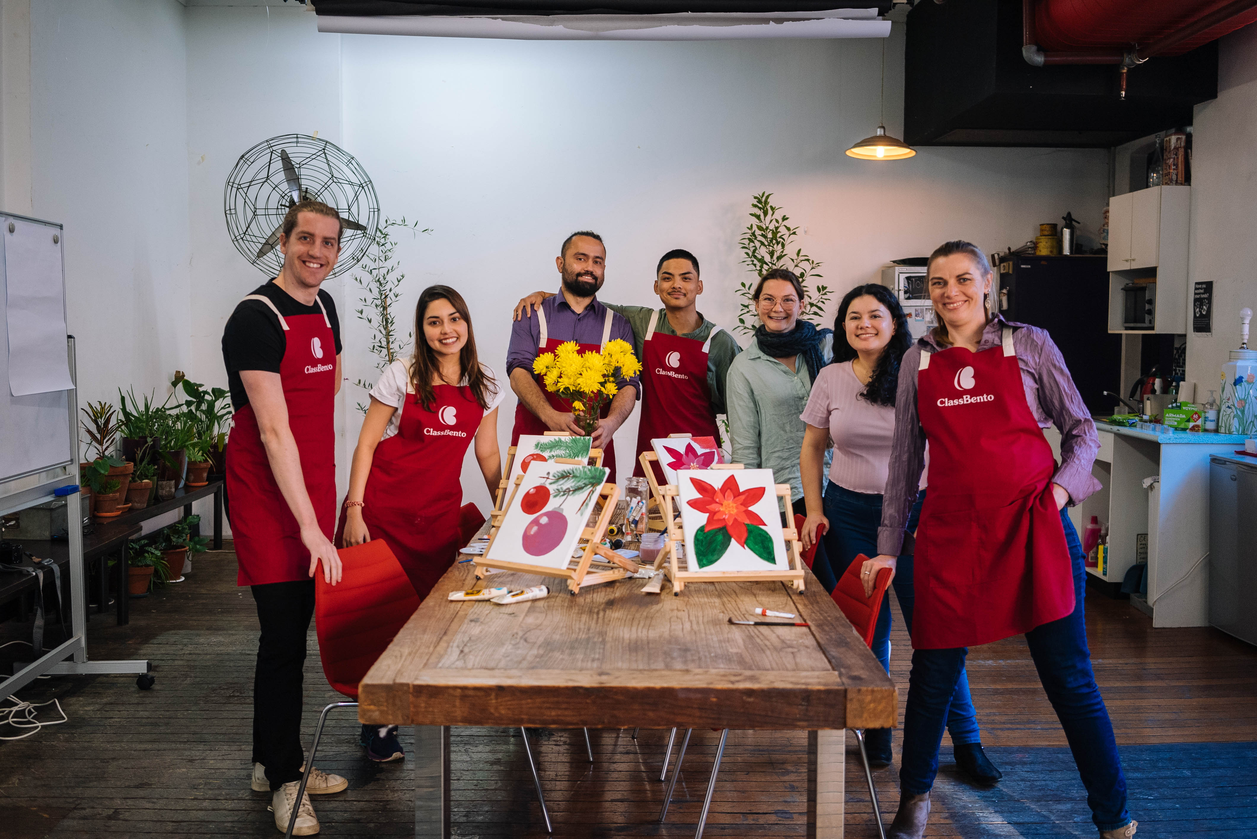 People smiling at a Christmas painting class