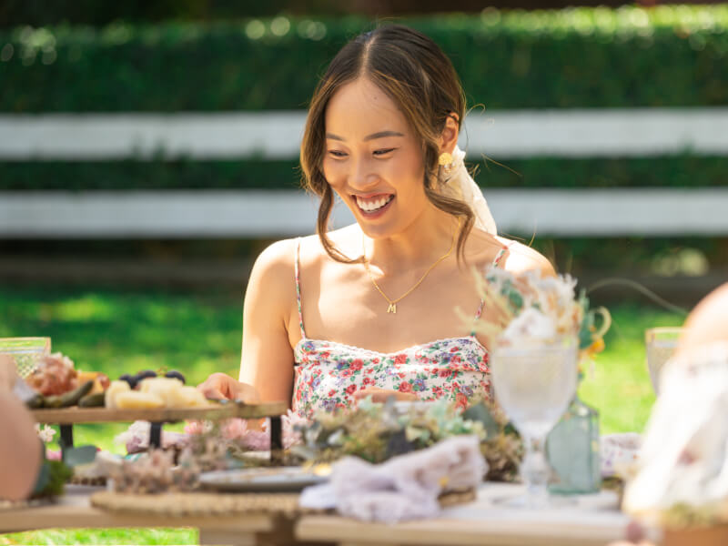 woman smiling at flower wreath class