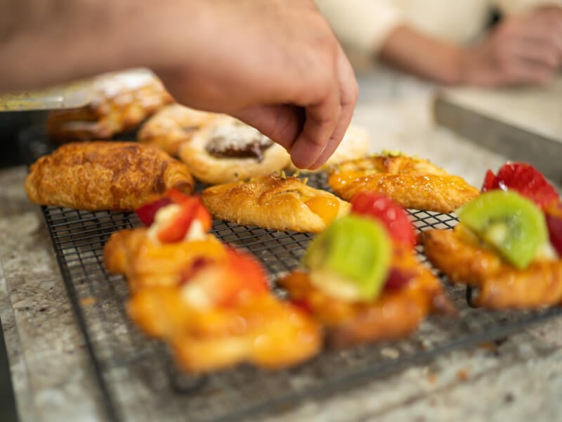 adding final touches to croissants and desserts
