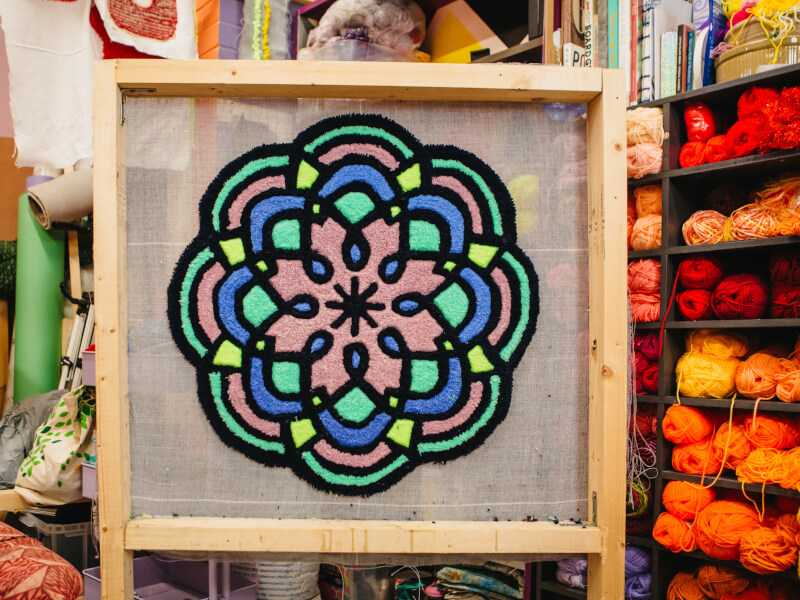 Geometric tufted run on a stand