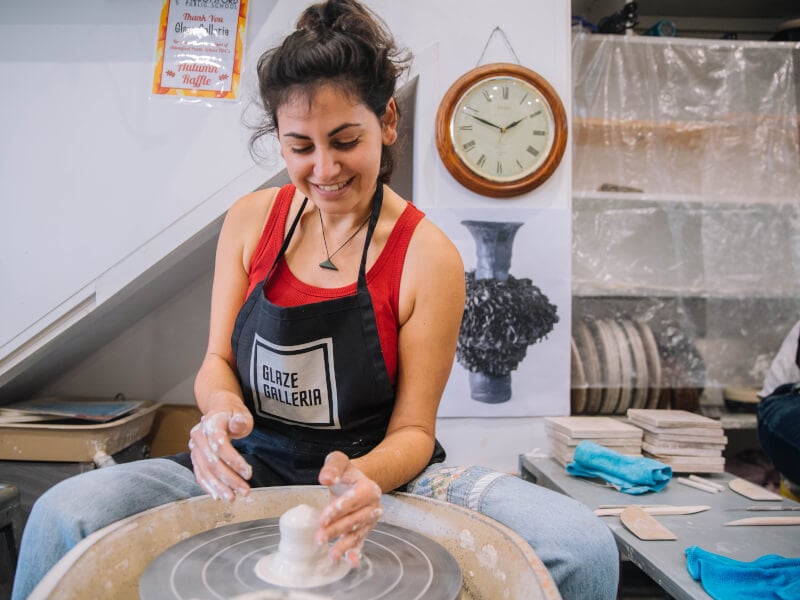Woman wheel throwing