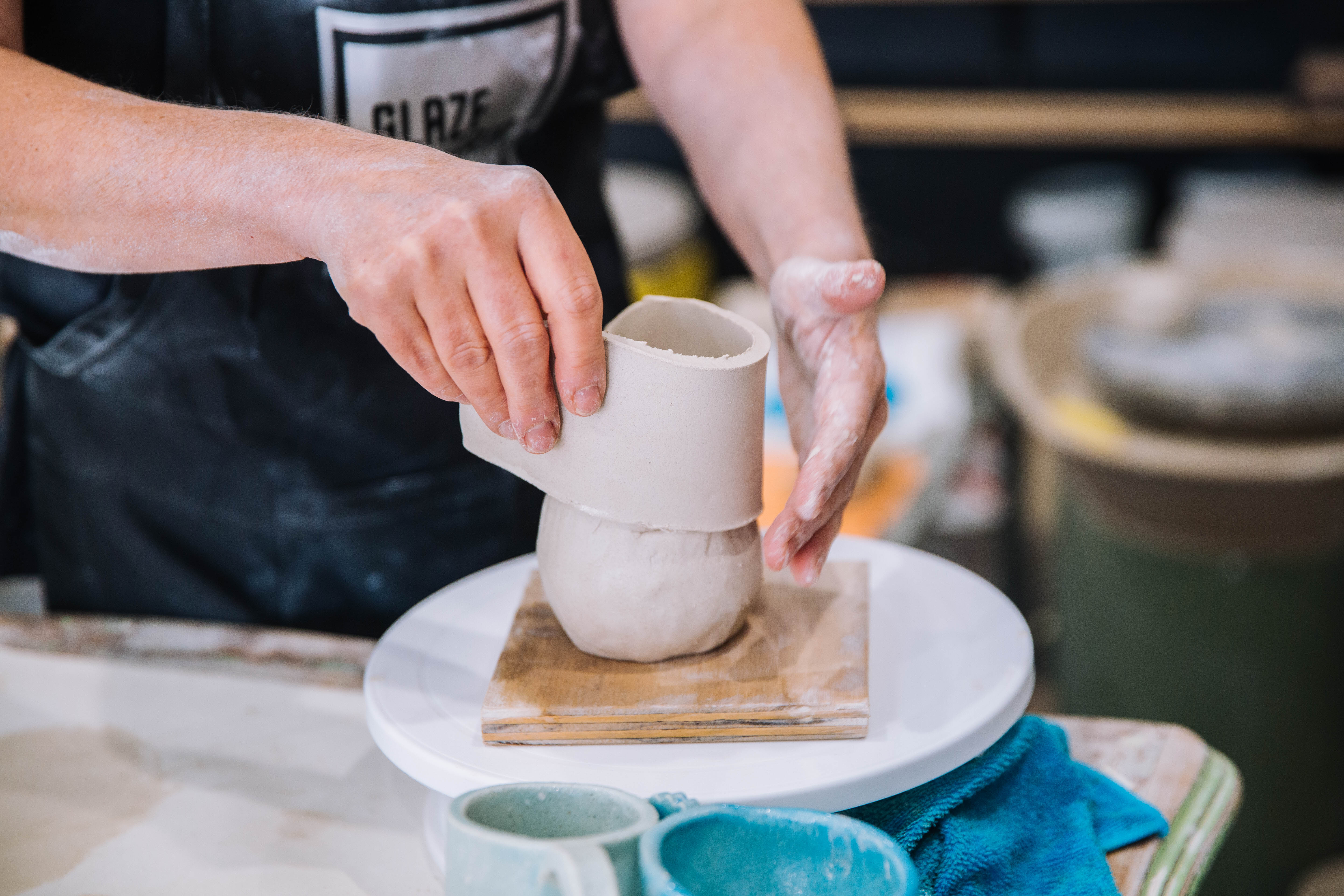 Close-up of woman hand building a mug