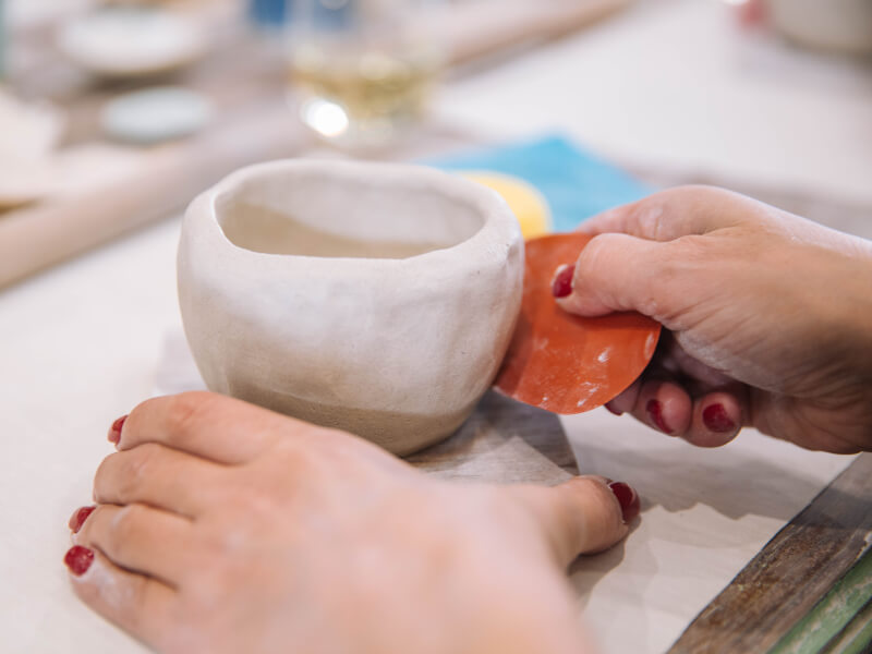 Close-up of woman hand building a mug
