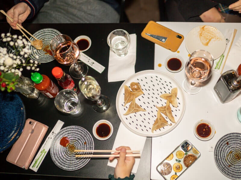 Table layout of people eating dumplings
