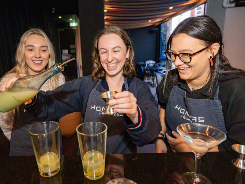 group of women making cocktails