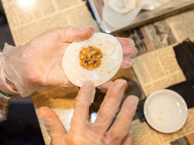 close up of wrapping dumplings