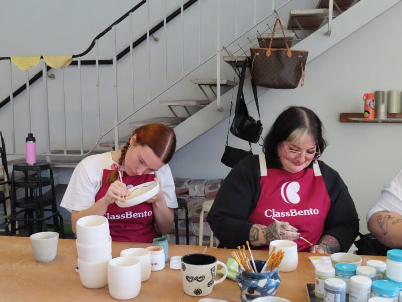 People painting ceramics in a studio