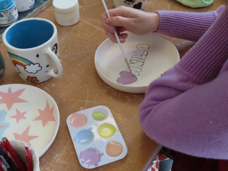 Woman painting ceramics