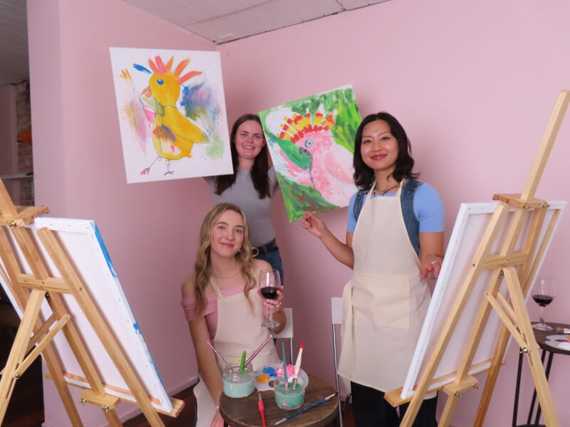 Team having fun at a paint and sip class