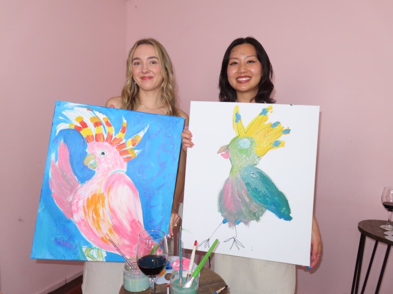 Colleagues showing off their finished artworks