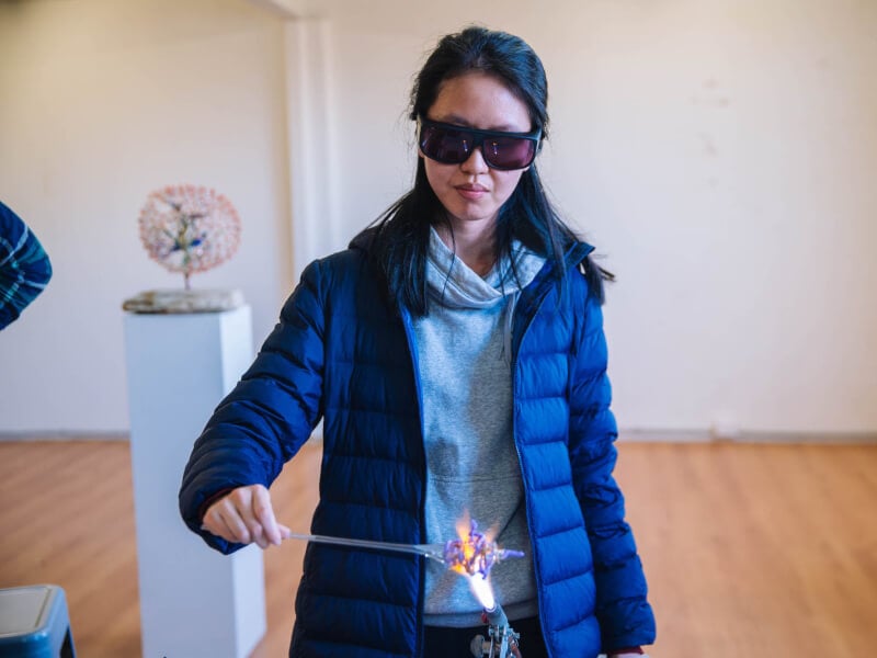 Young woman trying glassblowing in Melbourne