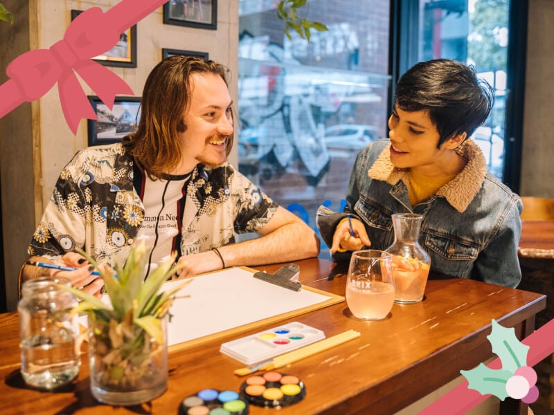 couple smiling at paint and sip class