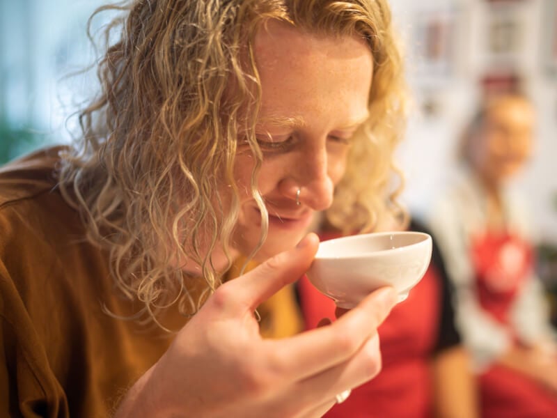 Young man sniffing ingredients at a couples cooking class in Sydney