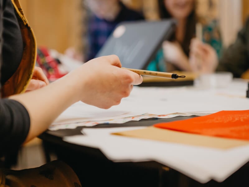 holding a calligraphy brush