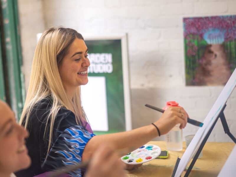 Woman painting at a paint and sip class in Canberra