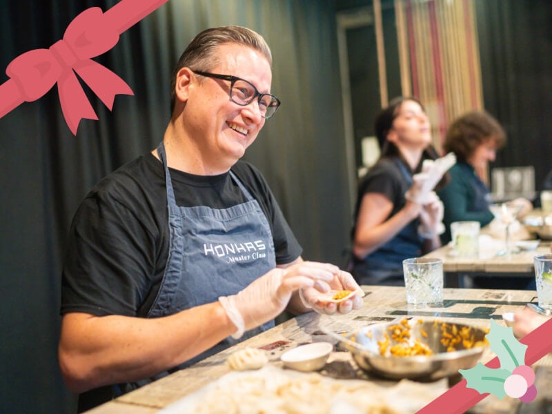 man smiling at dumpling making class