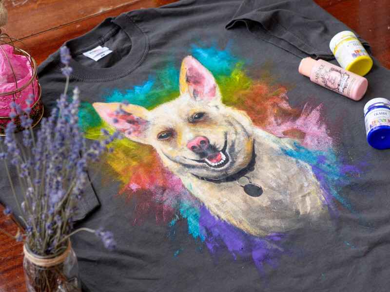 A dog painted on a tshirt at a paint your pet class
