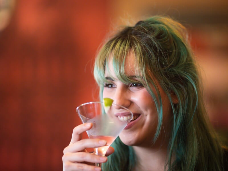 woman smiling with cosmopolitan cocktail