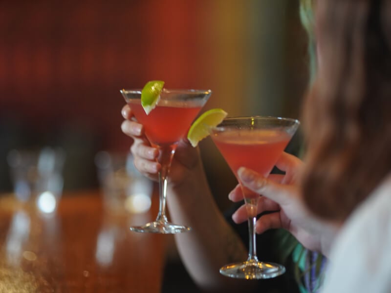 clinking cosmopolitan cocktails