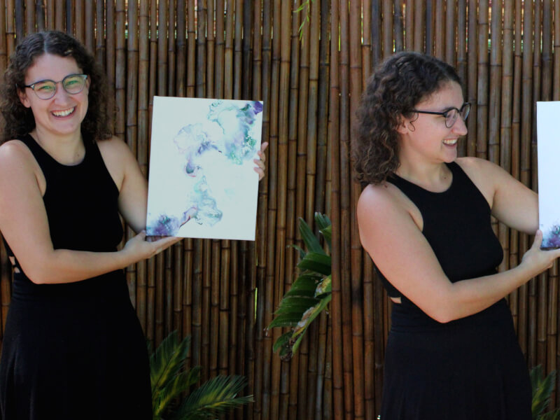 Kellie posing with her paint pouring artwork