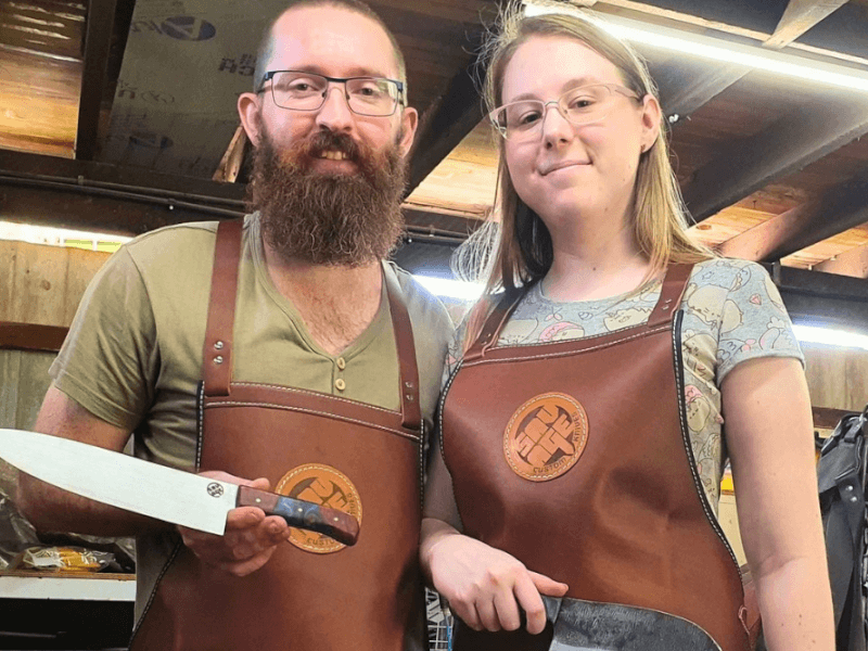 Happy guests with the knives they made at a knife making workshop