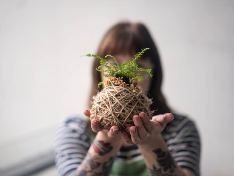 Woman holding Kokedama creation