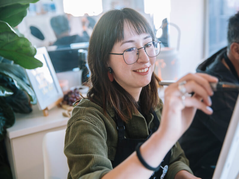 woman smiling at painting class