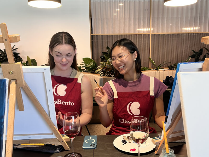 Women smiling at a painting class