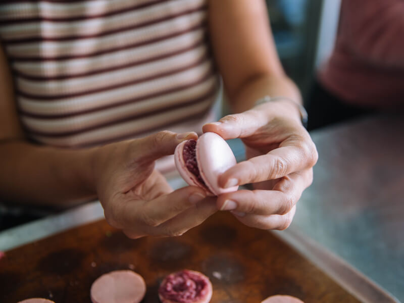 Close-up of woman putting together macaron shells