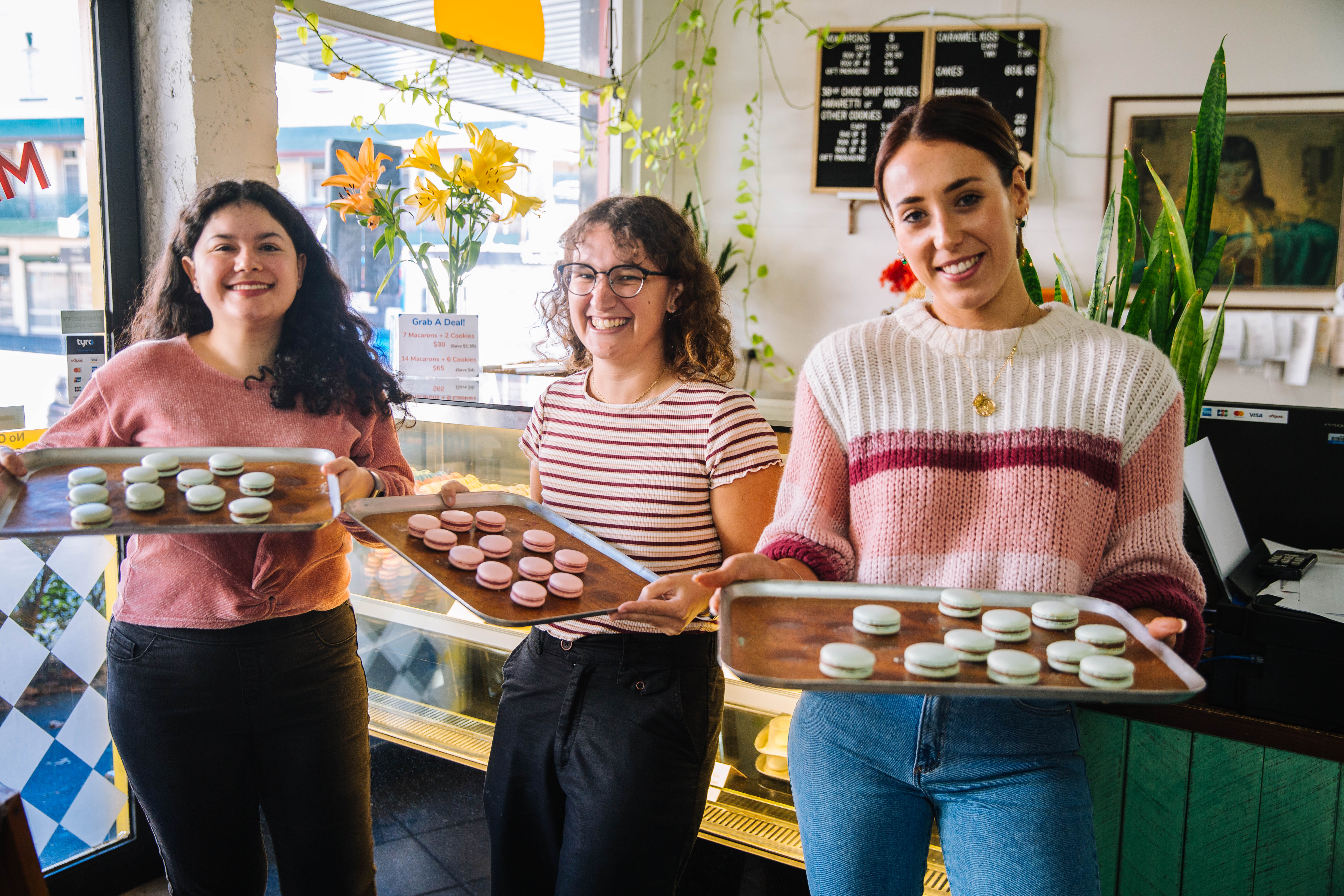 Group of women showing off their macarons